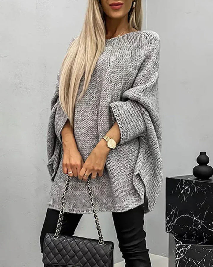 Damen Cape-Strickpullover in Grau mit weiten Ärmeln, aus weichem Material, lässiger Schnitt für bequemen Tragekomfort.