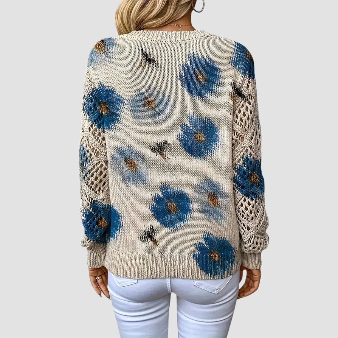 Damenpullover aus weicher Baumwolle, mit bunten Blumenmustern und  zarten Häkel-Details für einen verspielten Look.