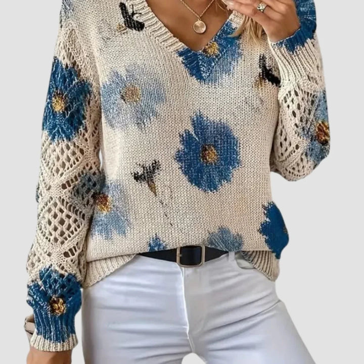 Damenpullover aus weicher Baumwolle mit floralem Muster und Häkel-Details an den Ärmelenden und dem Saum.