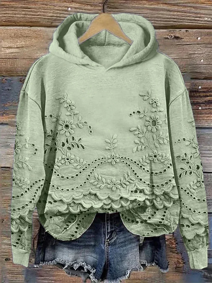 Grüner Kapuzenpullover aus weichem Material mit floraler Stickerei und lässigem Schnitt für einen entspannten Look.