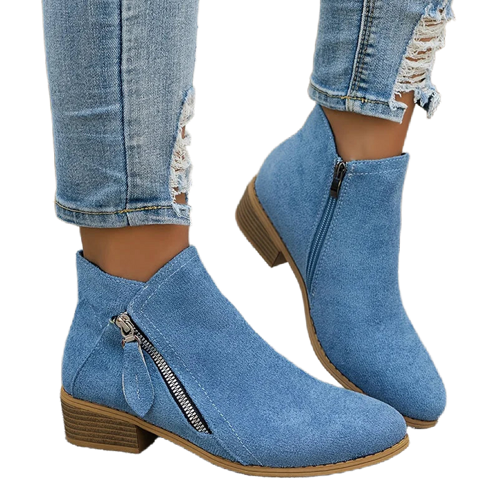 Damen Ankelstiefel aus schwarzem Leder mit seitlichem Reißverschluss und flachem Absatz für einen modernen Look.