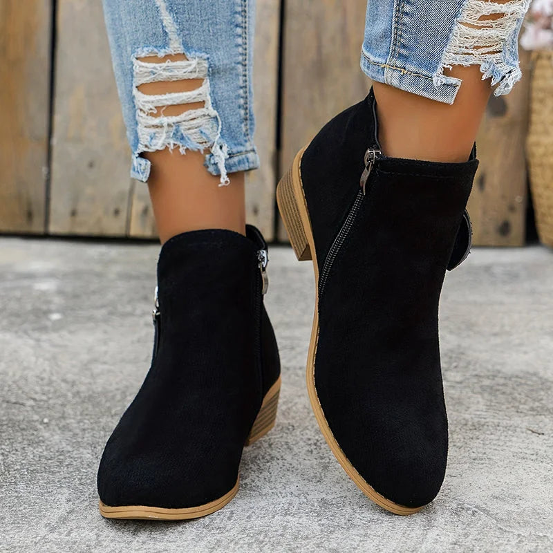 Damen Ankelstiefel aus robustem Leder mit seitlichem Reißverschluss und modischem, minimalistischen Design in Schwarz.