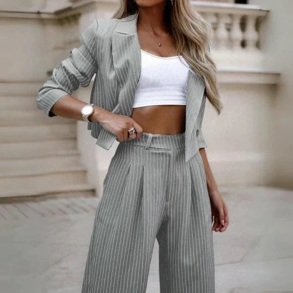 Damen Anzug Set in Grau mit Streifenmuster, bestehend aus einer Blazerjacke und Hose, aus leichtem, atmungsaktivem Material.