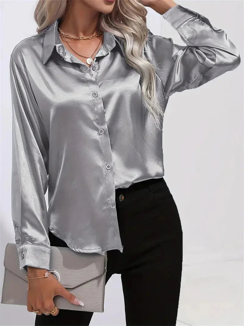 Damen Bluse aus silbergrauem Satin mit eleganten Knöpfen und klassischem Schnitt für vielseitige Outfits.