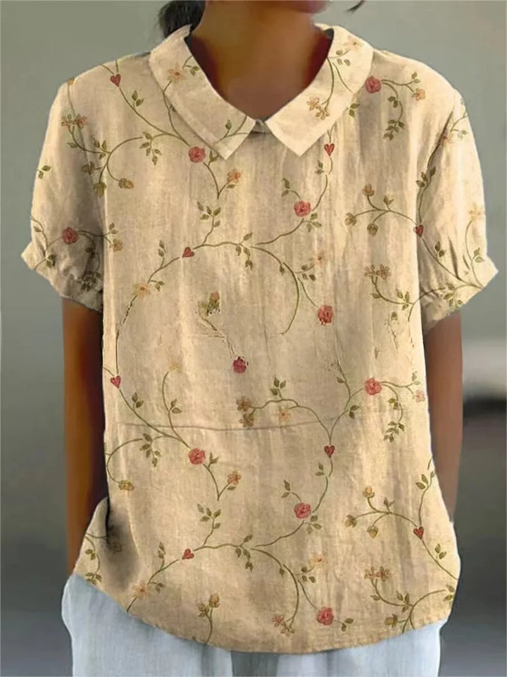 Gelbe Damenbluse aus leichtem Stoff mit floralem Stickmuster und kurzen Ärmeln, perfekt für den Sommer.