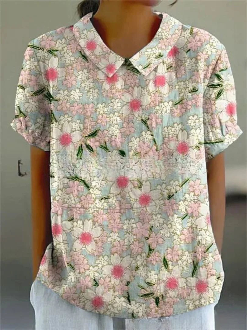 Weiße Damenbluse mit floralem Stickmuster und kurzen Ärmeln, aus hochwertigem Stoff, ideal für den Alltag oder besondere…