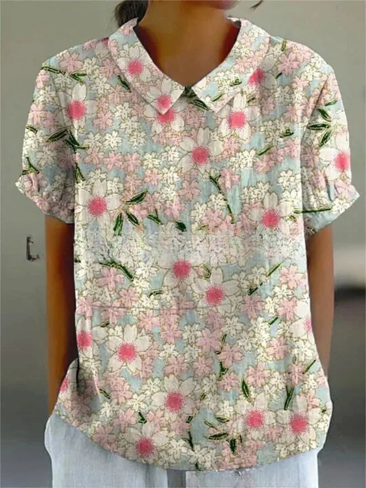 Weiße Damenbluse mit floralem Stickmuster und kurzen Ärmeln, aus hochwertigem Stoff, ideal für den Alltag oder besondere…