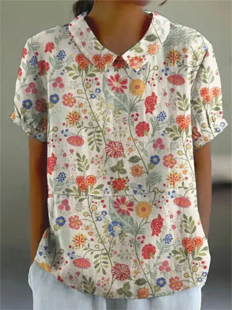 Damen Bluse mit floralem Stickmuster, kurzen Ärmeln in Weiß, Baumwollmischung, frühlingshaftes Design, elegant, vielseitig.