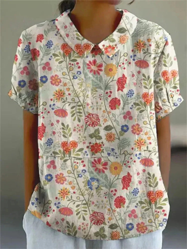 Damen Bluse mit floralem Stickmuster, kurzen Ärmeln in Weiß, Baumwollmischung, frühlingshaftes Design, elegant, vielseitig.
