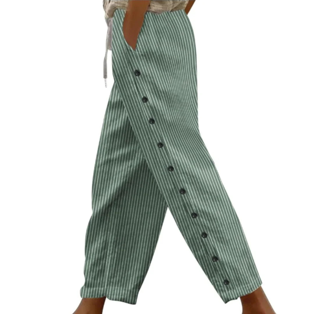 Frauen Caprihose aus grünem Stoff mit seitlichen Knöpfen und Streifenmuster. Schlichtes Design für casual Sommer-Looks.