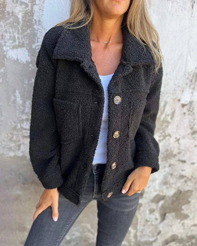 Schwarze Damen Fleecejacke mit Knopfverschluss, Brusttaschen und weichem Fleece-Material für zusätzlichen Komfort.