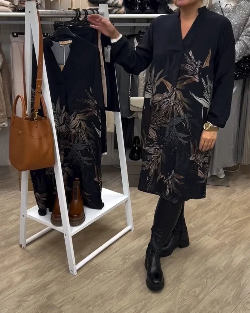 Damen Langarm Midi Kleid mit Blumenmuster in Schwarz, aus weichem Stoff, lässiger Schnitt und elegante Blütenmuster.