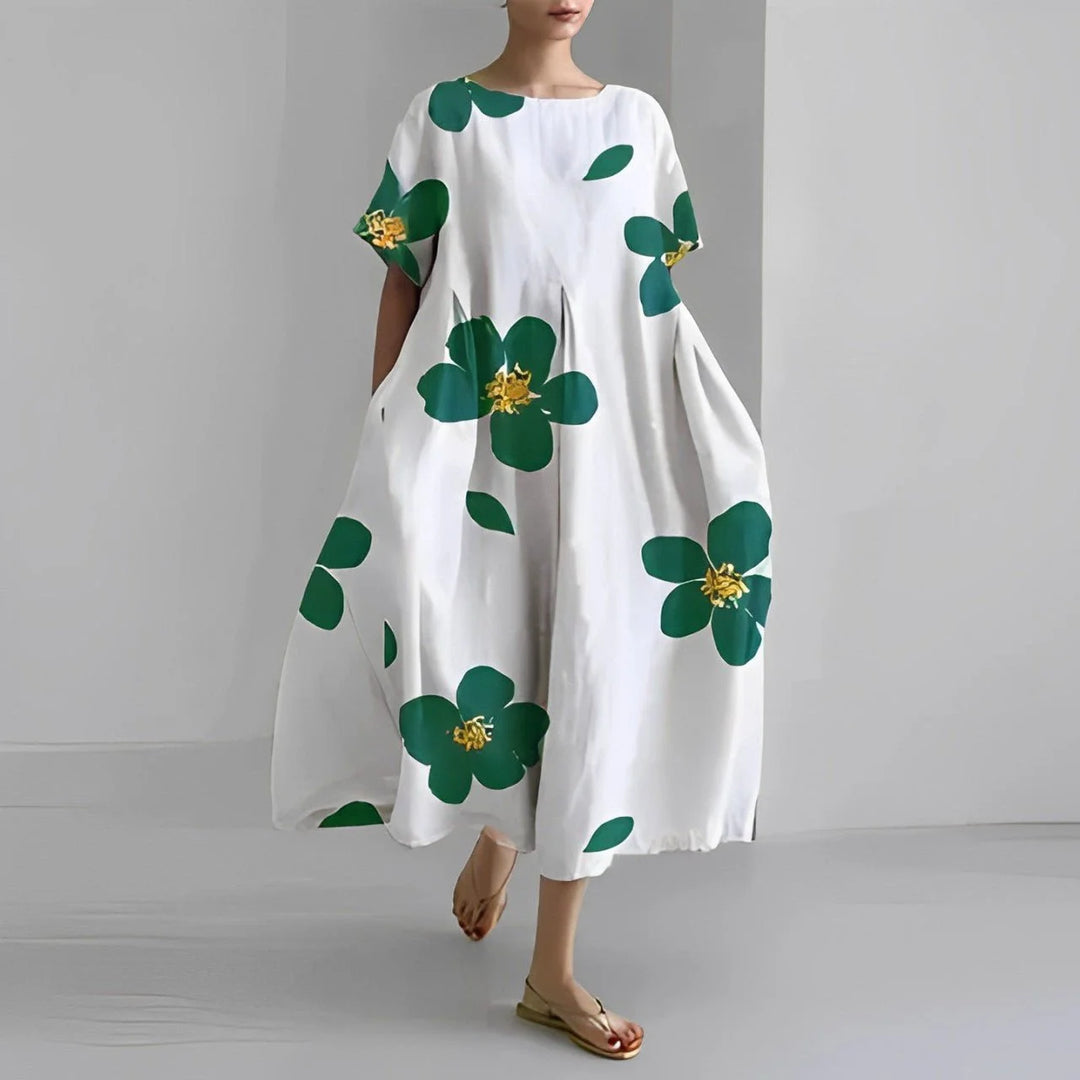 Damen Maxi-Kleid in Weiß mit Grünem Blumenprint, luftiger Stoff, sommerliches Design, ideal für warme Tage, bequemer Schnitt.
