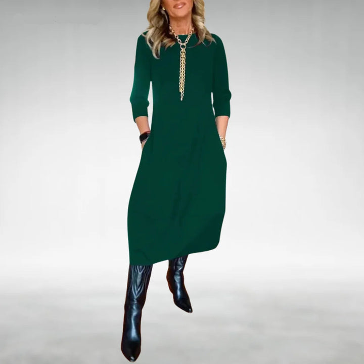 Grünes Damen Midikleid mit Dreiviertelärmeln und praktischen Taschen, aus leichtem Baumwollmaterial mit fließendem Schnitt.