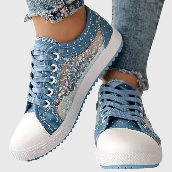 Damen orthopädische Sneakers aus atmungsaktivem Material mit buntem Blumendetail und bequemer Sohle für Alltag und Freizeit.