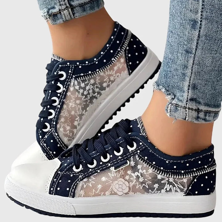 Damen Orthopädische Sneakers in Marineblau mit Blumendetail, aus atmungsaktivem Material und bequemem Fußbett.