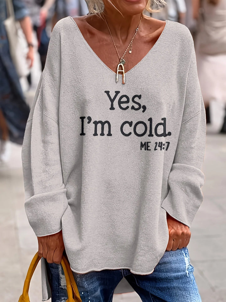 Hellgrauer Damen Oversize Pullover mit V-Ausschnitt, auffälligem Statement-Print und weichem, bequemen Material.