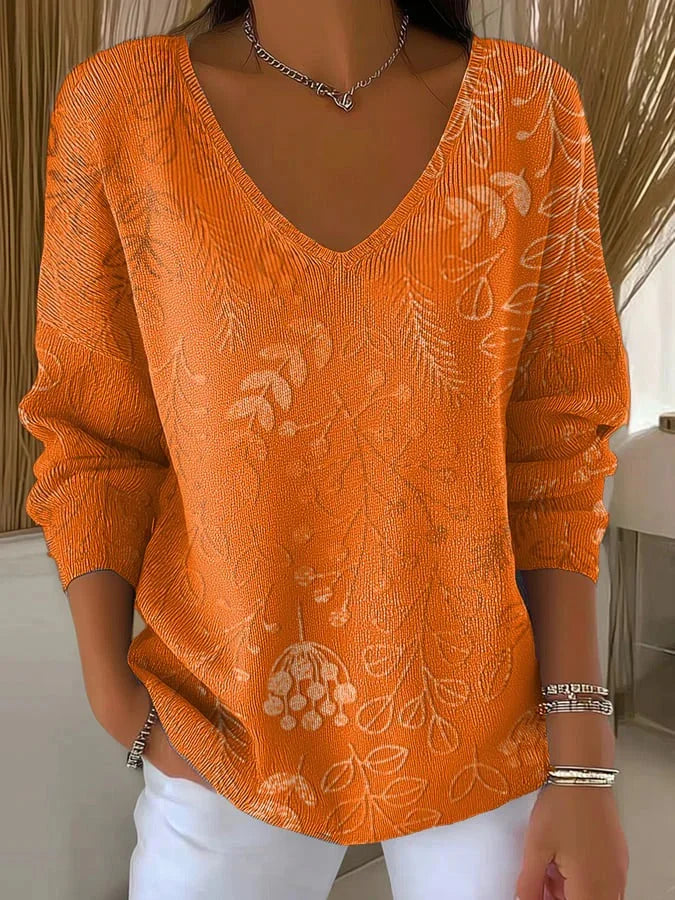 Damen Pullover in Orange mit V-Ausschnitt, floraler Musterung und weichem, atmungsaktivem Material für Komfort.