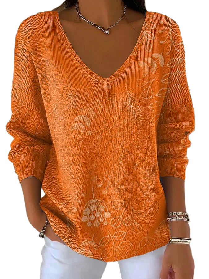 Damen Pullover in Orange mit V-Ausschnitt, floraler Musterung und weichem, atmungsaktivem Material für Komfort.