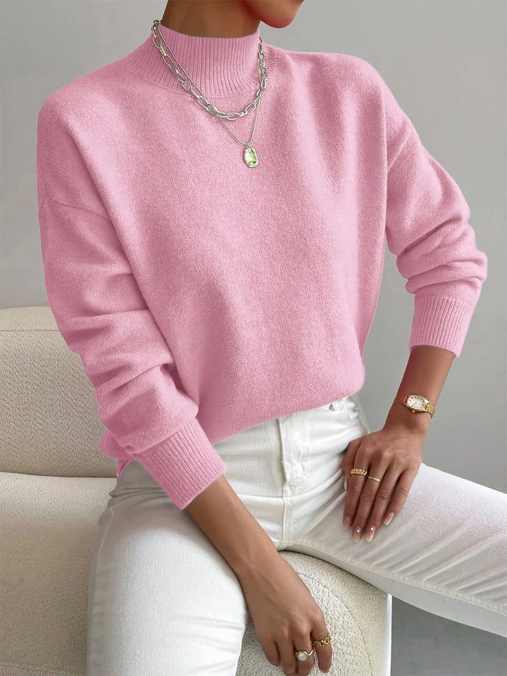 Hellrosa Damen Rollkragenpullover aus weicher Baumwolle, lockerer Schnitt und klassischen Rollkragen für Komfort an kühlen…