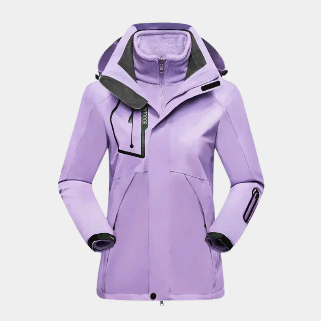 Damen Skijacke in Violett mit Fleecelinien, abnehmbarer Kapuze und robustem, wasserabweisendem Material.