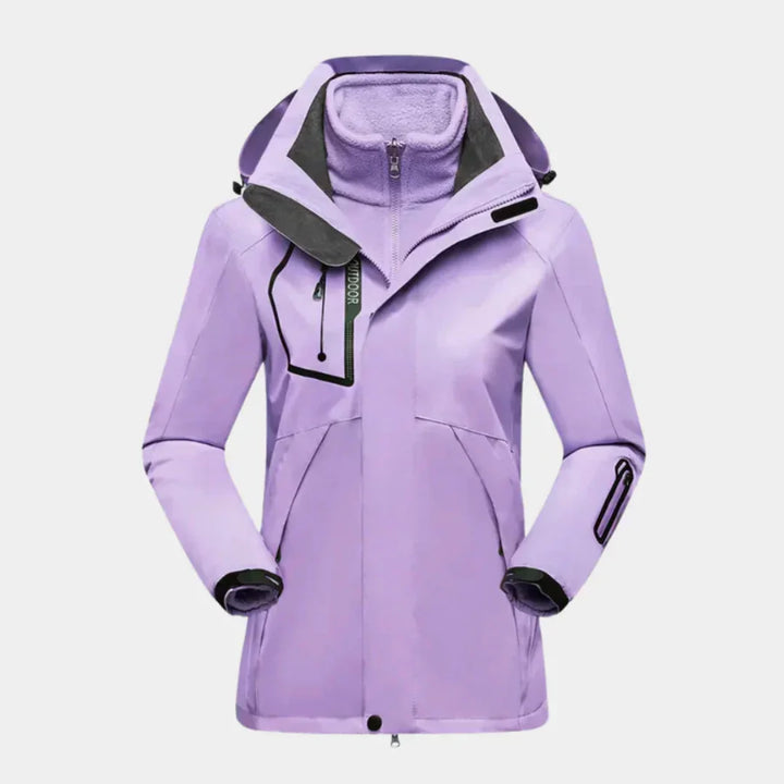 Damen Skijacke in Violett mit Fleecelinien, abnehmbarer Kapuze und robustem, wasserabweisendem Material.