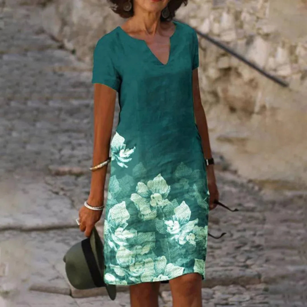 Grünes Damen Sommerkleid mit Blumendruck, V-Ausschnitt und luftigem Stoff - perfekt für sonnige Tage und entspannte Outfits.