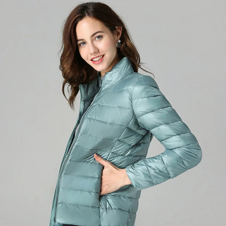 Damen Steppjacke gefüttert aus warmem Polyester mit Kapuze und seitlichen Taschen, ideal für kalte Tage.