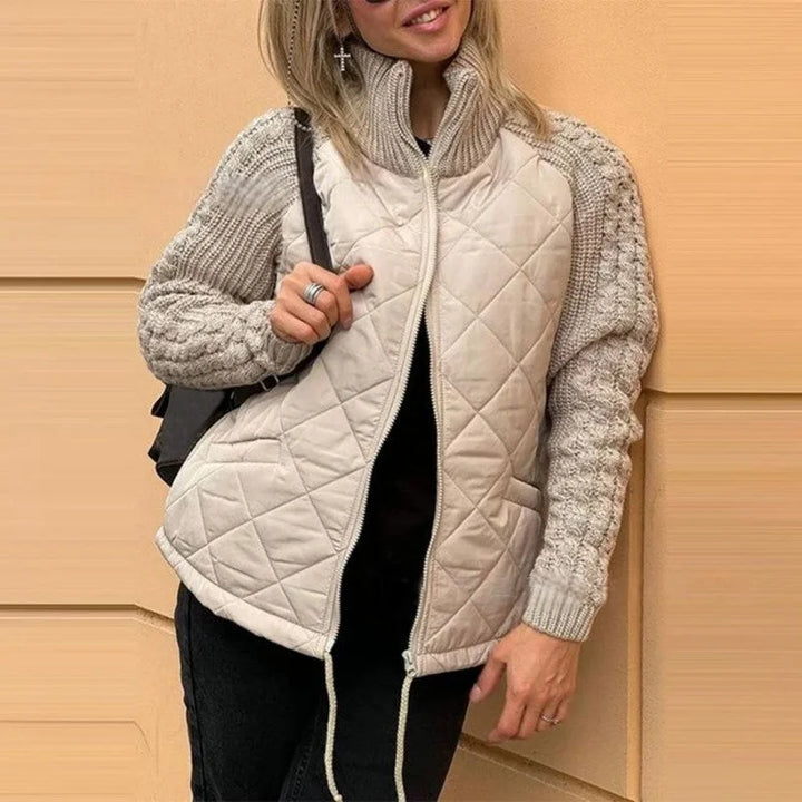 Damen Steppjacke in Sandbeige mit Strickärmeln, hohem Kragen und wärmendem Futter für angenehmen Tragekomfort.