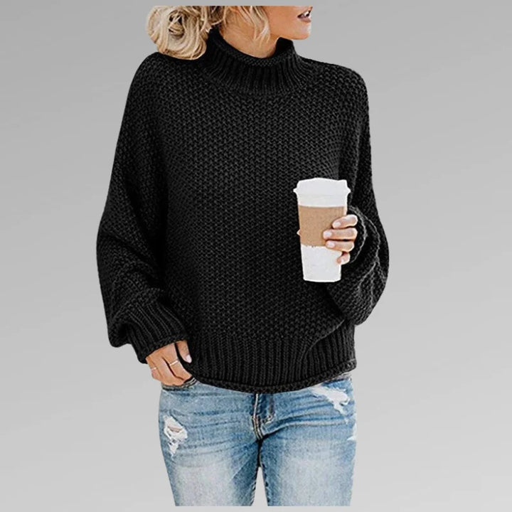 Damen Strickpullover in Schwarz, Rollkragen, lange Ärmel, aus weicher Baumwollmischung für angenehmen Tragekomfort.