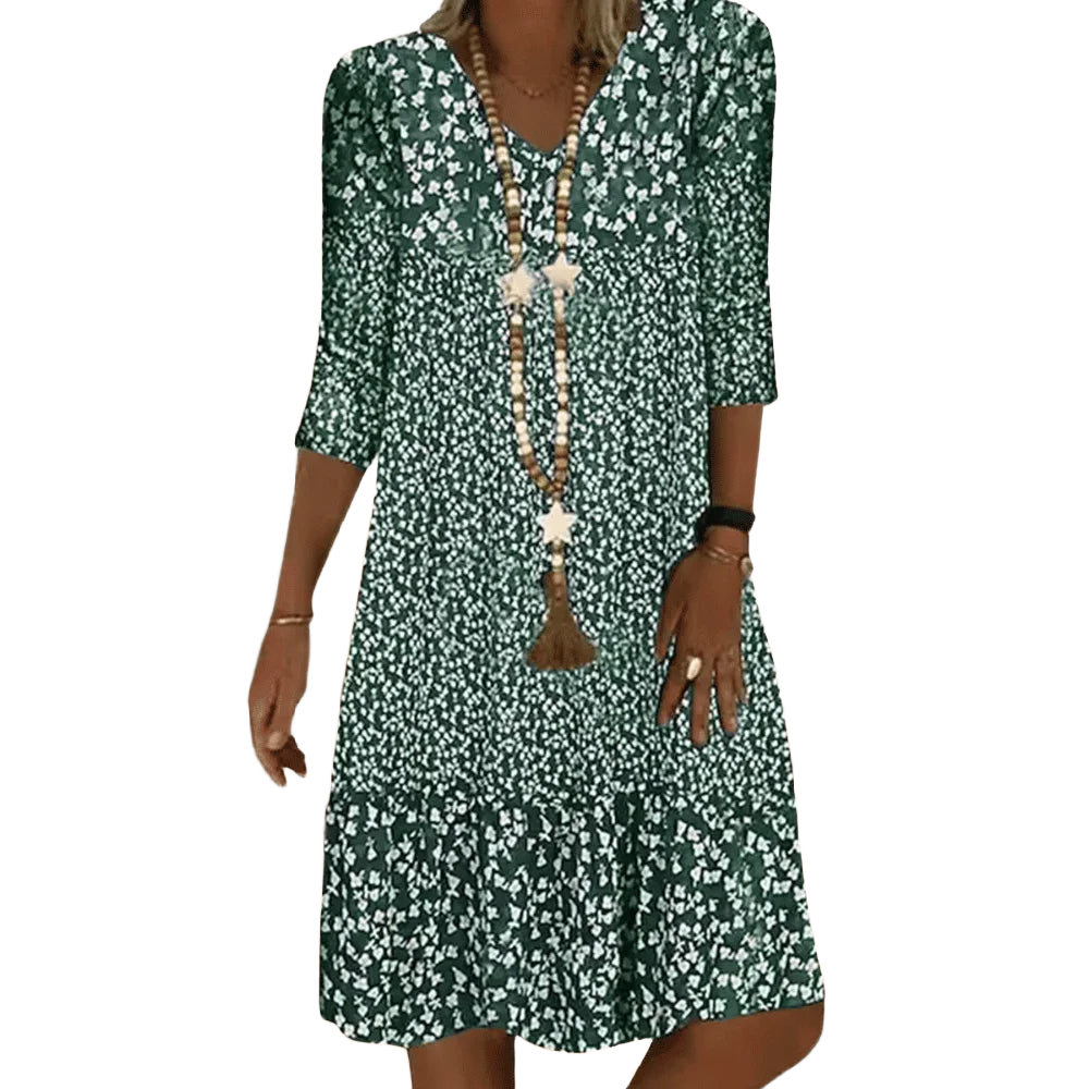 Grünes Damen Tunika-Kleid aus leichtem Stoff, mit V-Ausschnitt und Blumenmuster für einen sommerlichen Look.