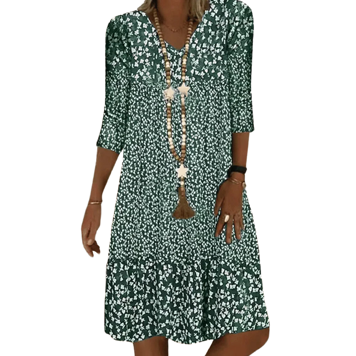 Grünes Damen Tunika-Kleid aus leichtem Stoff, mit V-Ausschnitt und Blumenmuster für einen sommerlichen Look.