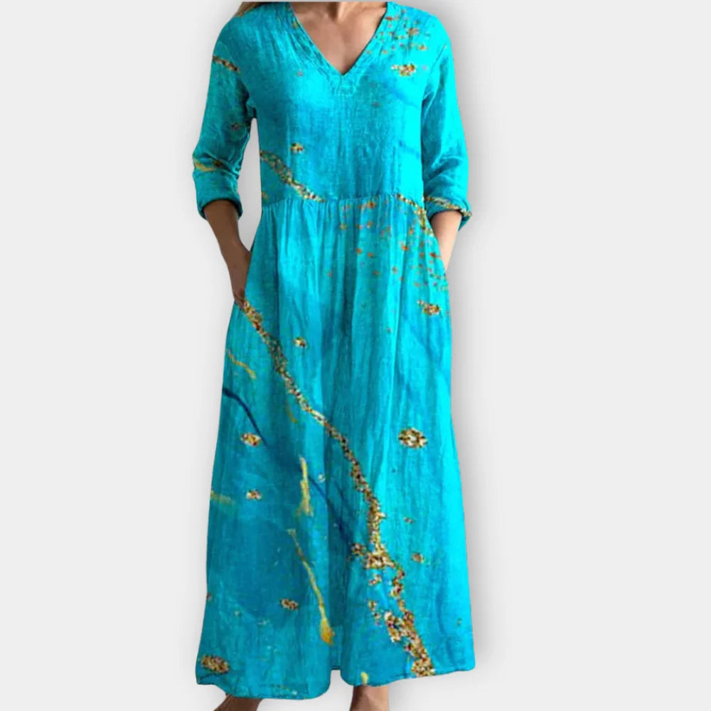 Türkisfarbenes Maxikleid für Damen mit V-Ausschnitt und schicken Mustern, ideal für sommerliche Anlässe.