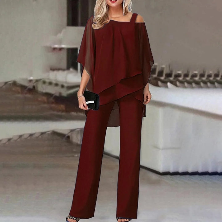 Damen Zweiteiler in Schwarz, bestehend aus Cold-Shoulder-Bluse und weiten Hosen, aus fließendem Stoff für lässig-eleganten…