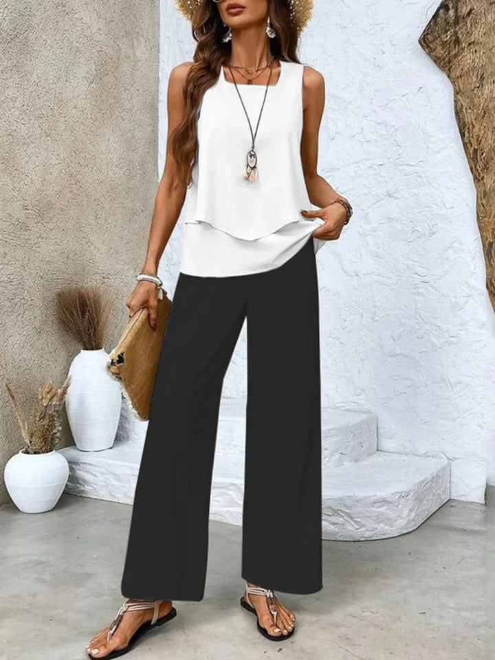 Schwarzes Zweiteiliges Damen-Set, ärmelloses Top und bedruckte Hose. Angenehmes Material, modernes Design, perfekt…