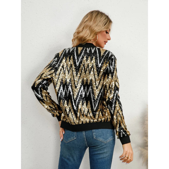 Damenjacke aus weichem Material mit funkelndem Paillettenmuster und praktischem Reißverschluss in Schwarz-Gold.