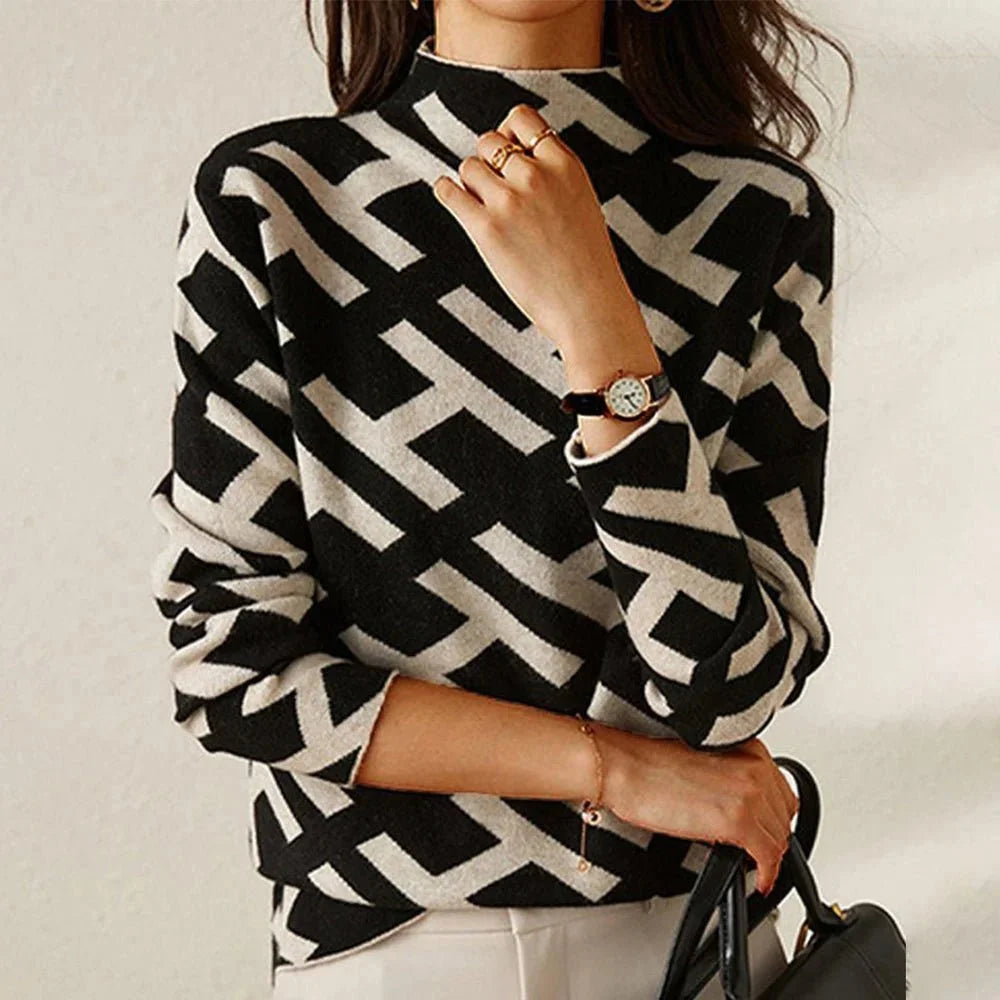 Schwarzer Damenpullover mit geometrischem Muster in Schwarz-Weiß aus weichem Material, ideal für den lässigen Alltag.
