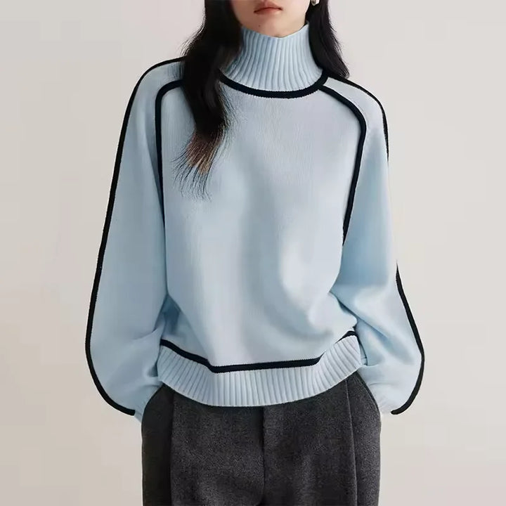 Blauer Rollkragenpullover aus weichem Strick für einen lässigen Herbst-Look mit lockerer Passform und langen Ärmeln.